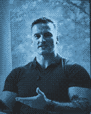 James Richman seated by a window, rendered as a blue dot pattern.